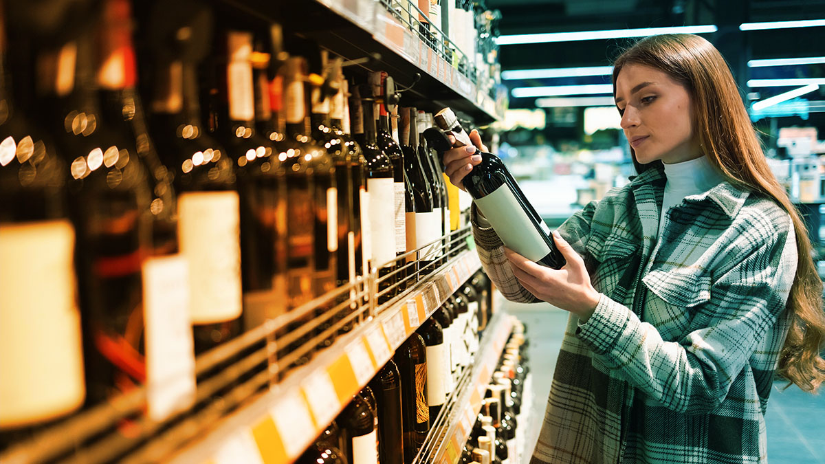 Person looking at a liquor bottle in store