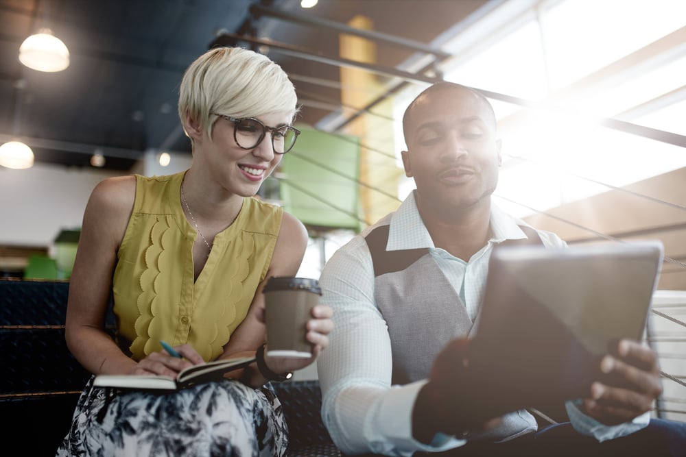 two people looking at a tablet
